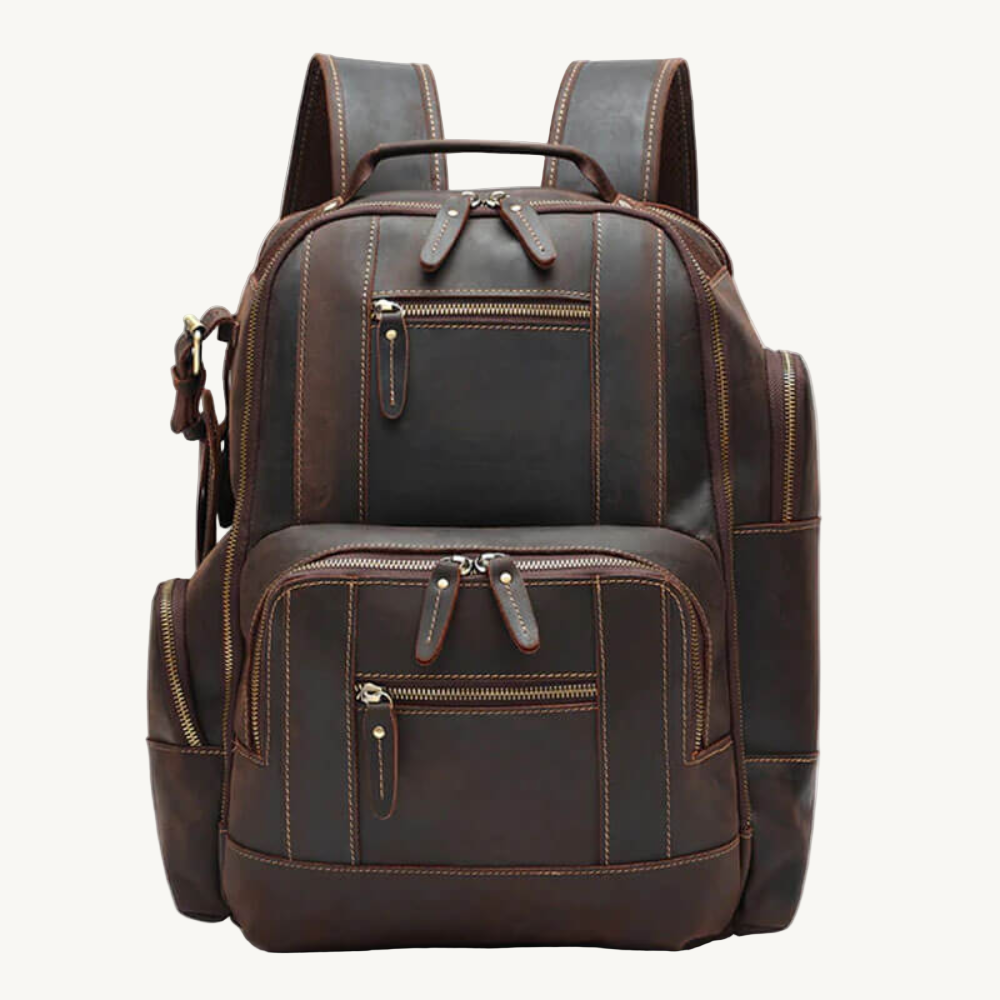 Brown leather backpack with multiple zippers on a white background