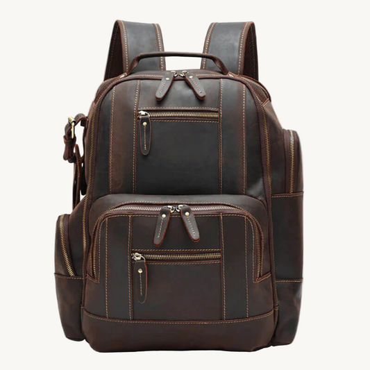 Brown leather backpack with multiple zippers on a white background