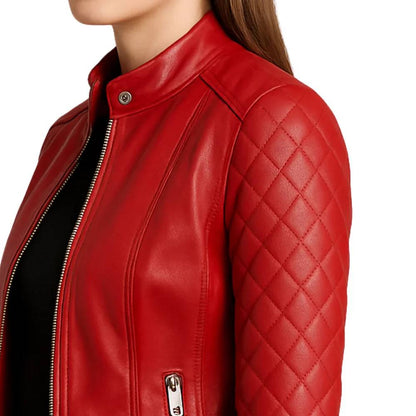 Women’s red quilted lambskin leather café racer jacket with shoulder quilting, asymmetrical left-side zipper, and a snap button collar.